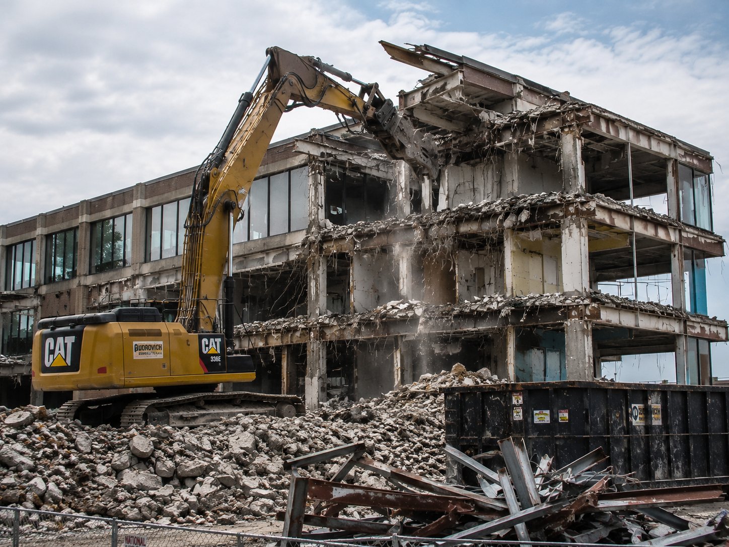 Commercial building demolition with CAT excavator